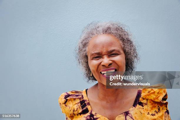 portrait of happy senior woman - world music stockfoto's en -beelden