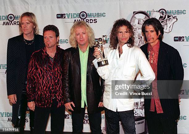 Lead singer Steven Tyler and his band Aerosmith pose after receiving the award for Best Rock Video for "Pink" during the 1998 MTV Video Music Awards...