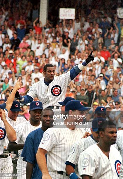 Chicago Cubs' Sammy Sosa is carried off the field on his teammates' shoulders after hitting his 61st and 62nd homeruns of the year in a Cubs 11-10...