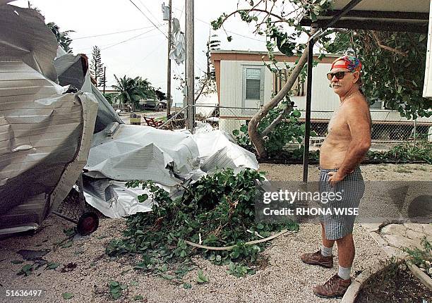 Florida Keys' resident Don Irwin looks 26 September at a roof that flew off of a neighbor's mobile home after Hurricane Georges ripped through the...