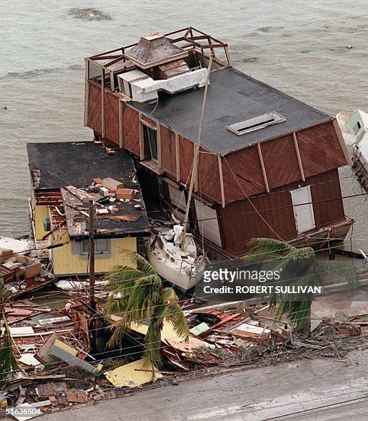 Houseboats sandwich a sailboat along Houseboat Row after being hit by Hurricane Georges 26 September on Key West, FL. The eye of Georges has passed...