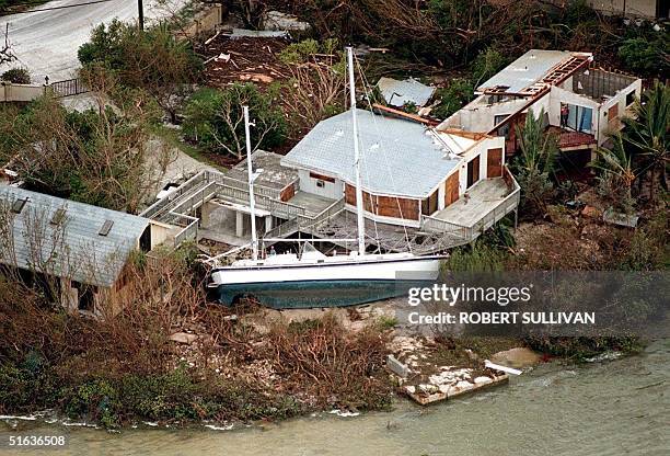 Sailboat lays next to a house 26 September after being displaced by Hurricane Georges on Big Pine Key, FL. The eye of Georges is passed over Key...