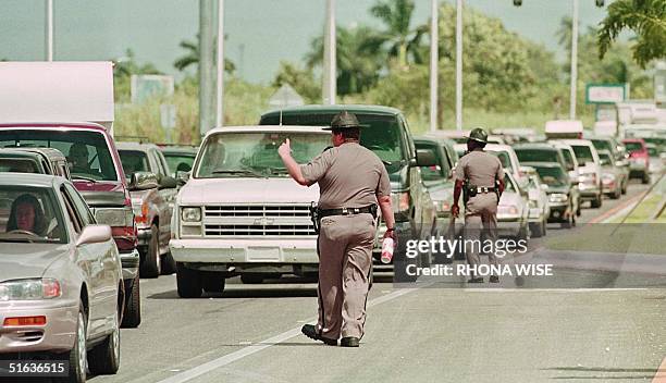 Florida State Troopers direct traffic outside FLorida City, Florida 26 September as residents of the Florida Keys wait on US1 for hours to return to...
