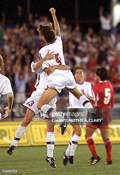 Soccer team forward Mia Hamm jumps into the arms of teammate Kristine Lilly after Hamm scored the first of her two goals during the 2nd half of the...