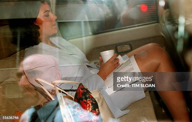Former White House intern Monica Lewinsky is photographed through a window of a car 28 July outside of her attorneys' office in Washington, DC....