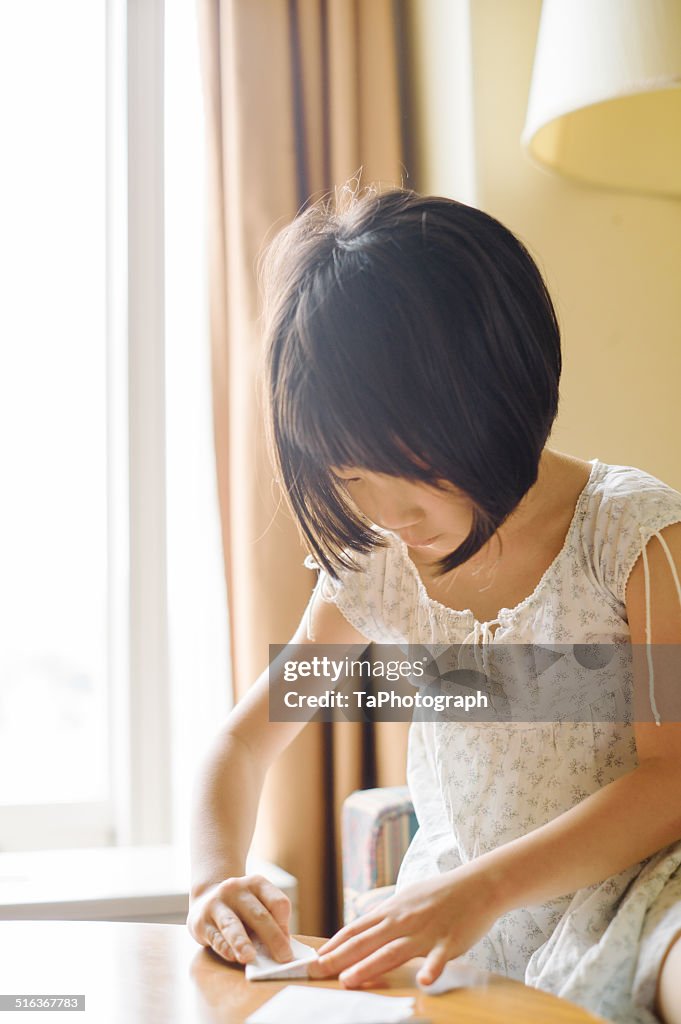 Girl folding up a letter