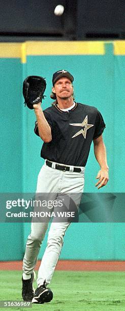 Houston Astro's pitcher Randy Johnson shags fly balls during batting practice for his new teammates 03 August before the Astro's game against the...