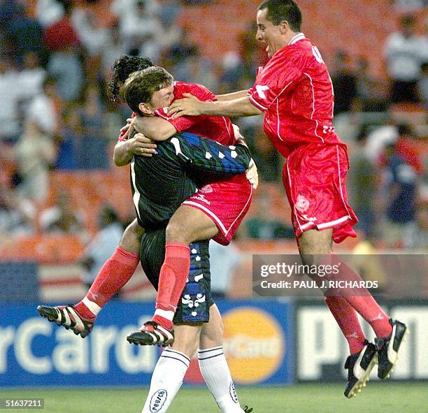 Toluca F.C. Goalie Herman Cristante is congratulated by teammates after deflecting shoot-out kicks for Toluca's 2-1 win over Deportivo Saprissa...