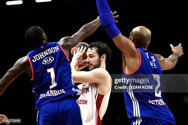 Cedevita Zagreb's Miro Bilan vies for the ball with Anadolu Efes' Elijah Johnson and Alex Tyus during the Euroleague top 16 basketball match between...