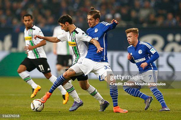 Lars Stindl of Borussia Monchengladbach and Roman Neustadter of Schalke battle for the ball during the Bundesliga match between FC Schalke 04 and...