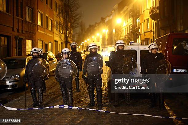 Police officers patrol after raids in which several people, including Paris attacks suspect Salah Abdeslam, were arrested on March 18, 2016 in...