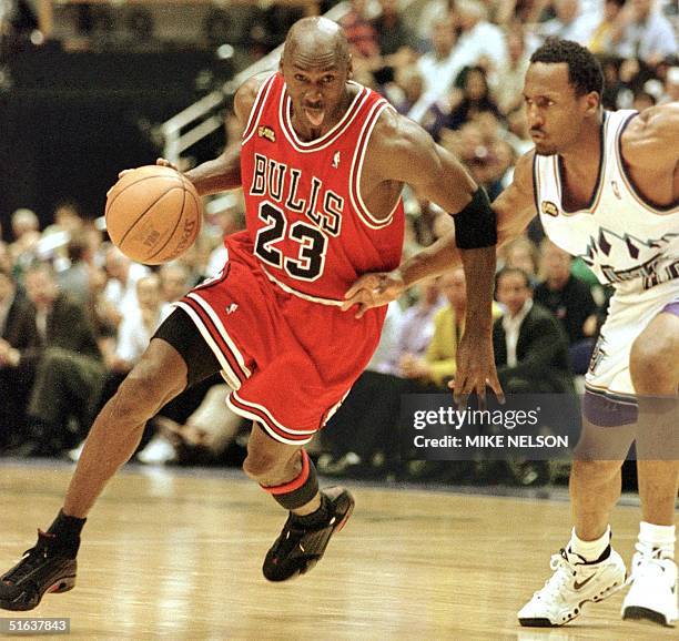 Michael Jordan of the Chicago Bulls goes to the basket past Shandon Anderson of the Utah Jazz 14 June during game six of the NBA Finals at the Delta...