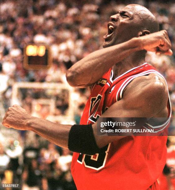 Michael Jordan of the Chicago Bulls celebrates 14 June after winning game six of the NBA Finals against the Utah Jazz at the Delta Center in Salt...