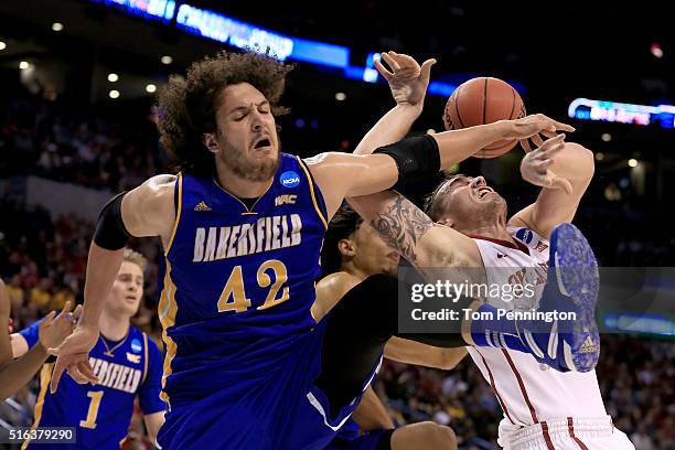 Aly Ahmed of the Cal State Bakersfield Roadrunners and Ryan Spangler of the Oklahoma Sooners go after the ball in the first half in the first round...