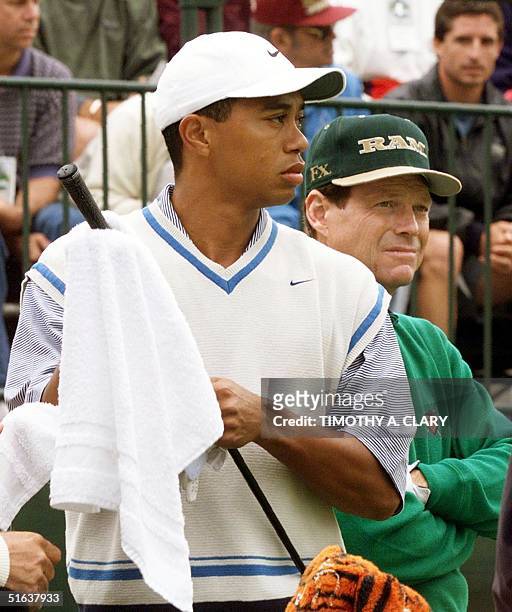 Golfers Tiger Woods and Tom Watson wait to tee off on the first tee before the start of their opening round of the US Open Championship 18 June at...