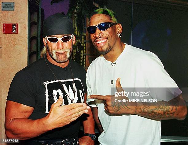 Professional basketball player Dennis Rodman of the Chicago Bulls poses with World Champion Professional wrestler Hollywood Hulk Hogan following a...