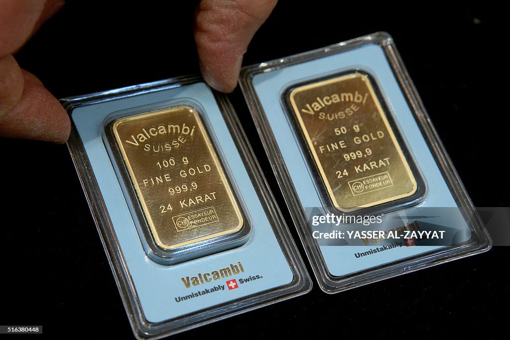 Kuwait Values A Kuwaiti jeweller displays gold bars at his shop in downtown Kuwait ...