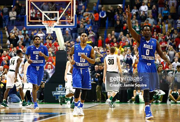 Perrin Buford, Jaqawn Raymond and Darnell Harris of the Middle Tennessee Blue Raiders leave the court after defeating the Michigan State Spartans...
