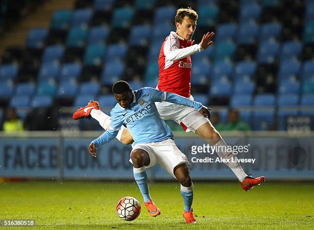 Aaron Nemane of Manchester City holds off a challenge from Ben Sheaf of Arsenal during the FA Youth Cup Semi Final, First Leg match between...