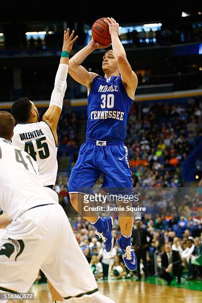 Reggie Upshaw of the Middle Tennessee Blue Raiders shoots against Denzel Valentine of the Michigan State Spartans in the second half during the first...