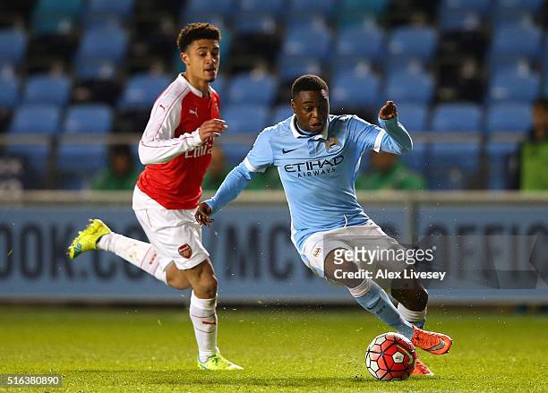 Aaron Nemane of Manchester City beats Chiori Johnson of Arsenal during the FA Youth Cup Semi Final, First Leg match between Manchester City and...