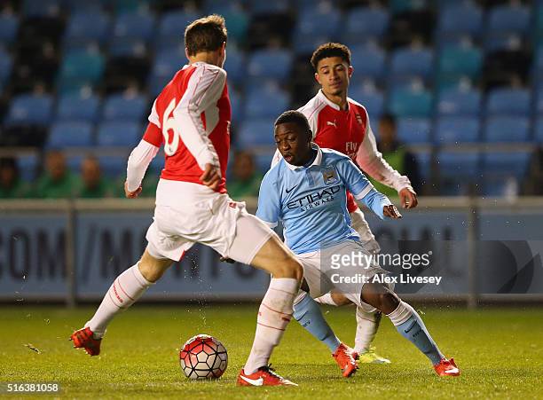 Aaron Nemane of Manchester City beats Krystian Bielik and Chiori Johnson of Arsenal during the FA Youth Cup Semi Final, First Leg match between...