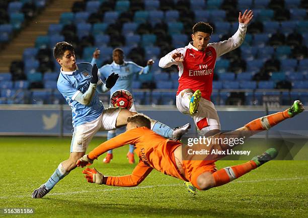 Hugo Keto and Chiori Johnson of Arsenal stop Brahim Diaz of Manchester City during the FA Youth Cup Semi Final, First Leg match between Manchester...