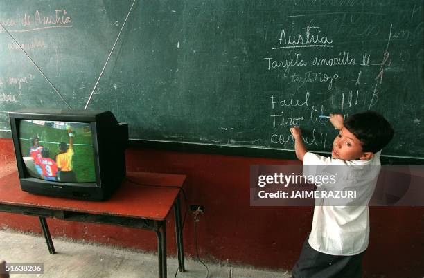 Student at the "Republica de Paraguay" elementary school in Lima tabulates on the blackboard the number of fouls committed by the Austrian national...