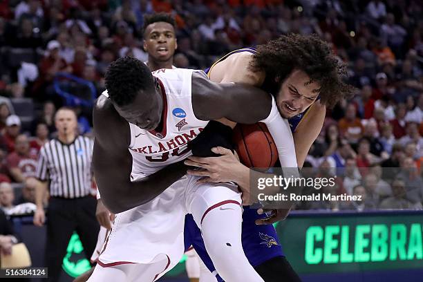 Akolda Manyang of the Oklahoma Sooners and Aly Ahmed of the Cal State Bakersfield Roadrunners battle for the ball in the second half in the first...