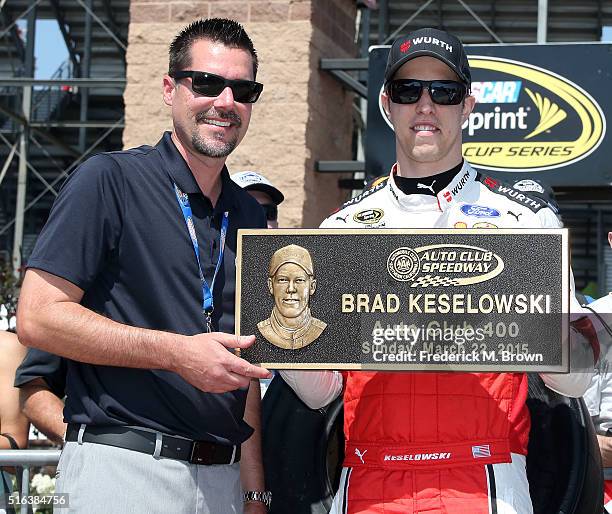 Dave Allen, President of the Auto Club Speedway, and race car driver Brad Keselowski react during Keselowski's Walk of Fame Induction Ceremony at the...