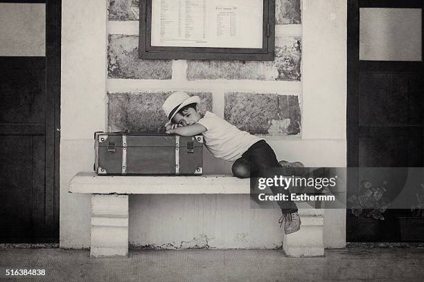 child waiting for the train with a red suitcase - orphan train stock pictures, royalty-free photos & images