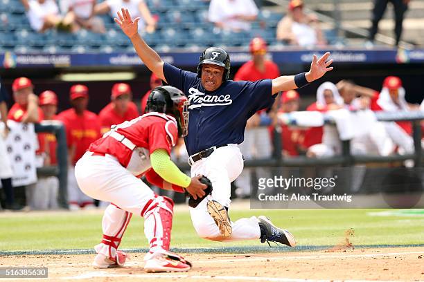 Ernesto Martinez of Team France slides into home during Game 3 of the World Baseball Classic Qualifier against Team Spain at Rod Carew Stadium on...