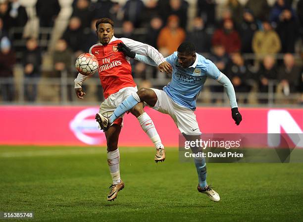 Tyrell Robinson of Arsenal takes on Isaac Buckley-Ricketts of Man City during the match between Manchester City and Arsenal in the FA Youth Cup semi...