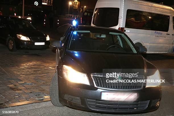 Special police forces are seen in a car at the Saint-Pierre hospital in Brussels, on March 18, 2016 where Salah Abdeslam was admitted after being...