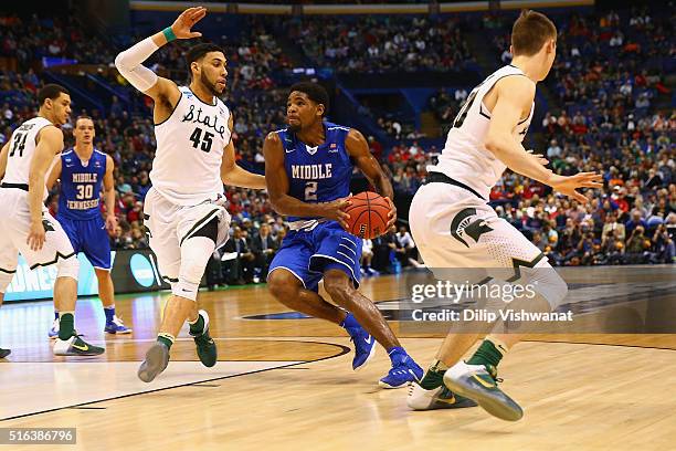 Denzel Valentine of the Michigan State Spartans defends against Perrin Buford of the Middle Tennessee Blue Raiders during the first round of the NCAA...