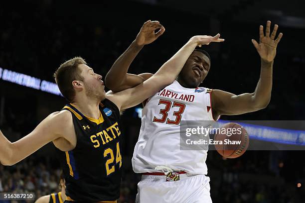 Mike Daum of the South Dakota State Jackrabbits fouls Diamond Stone of the Maryland Terrapins in the second half during the first round of the 2016...