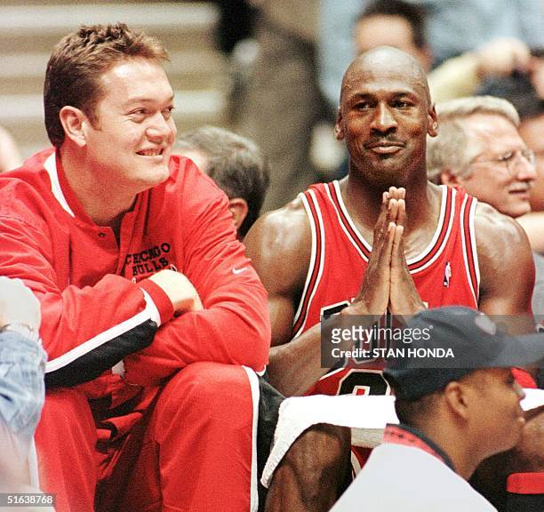 Luc Longley and Michael Jordan of the Chicago Bulls celebrate their win over the New Jersey Nets, 116-101, in the first round of playoffs 29 April at...