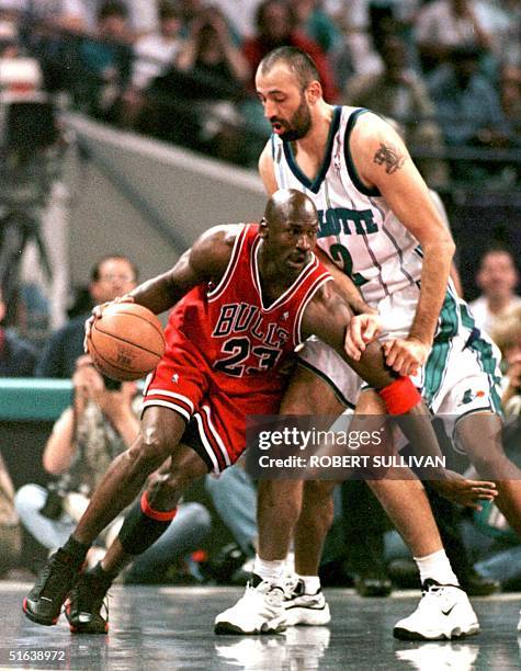 Michael Jordan of the Chicago Bulls drives past Vlade Divac of the Charlotte Hornets 08 May during the first quarter of game three of their Eastern...