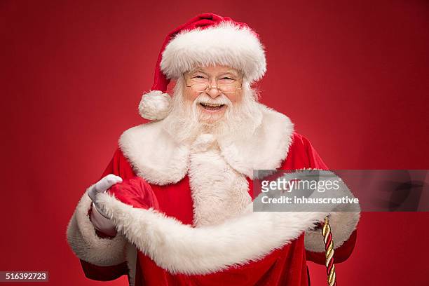 real santa claus opening gift bag - santa clause stockfoto's en -beelden
