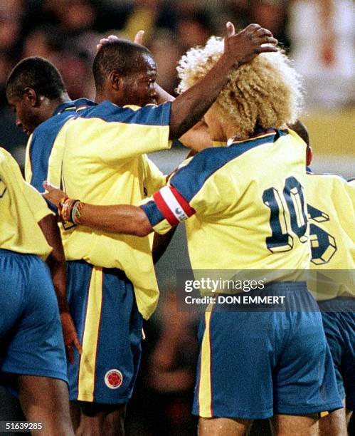 Colombia's Carlos Valderrama is congratulated by teammate Faustino Asprilla after making a free kick to score against Scotland goalkeeper Neil...