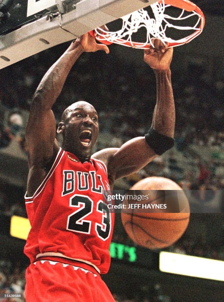 Michael Jordan of the Chicago Bulls hang son the r