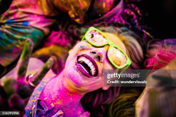 close up face shot of girl covered in holi powder - woman holi stock pictures, royalty-free photos & images