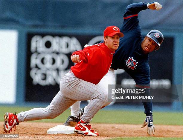 Cincinnati Reds infielder Bret Boone looks for the umpire's call as Toronto Blue Jays outfielder Shannon Stewart steals second base during the fifth...