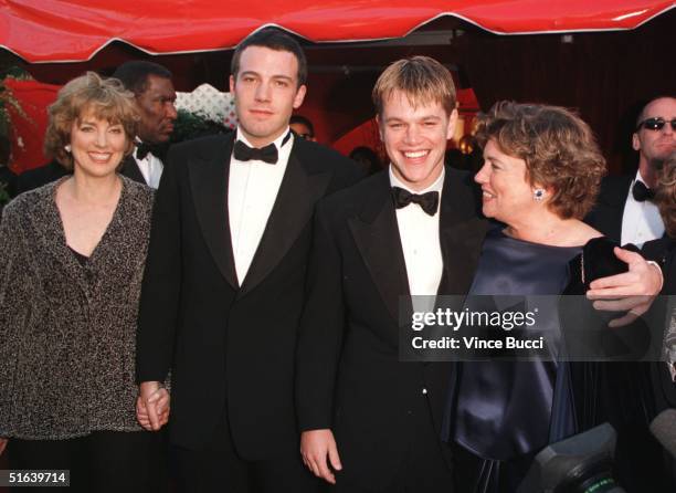 Actor-writers Ben Affleck and Matt Damon arrive with their mothers Chris and Nancy at the 70th Annual Academy Awards 23 March in Los Angeles, CA....