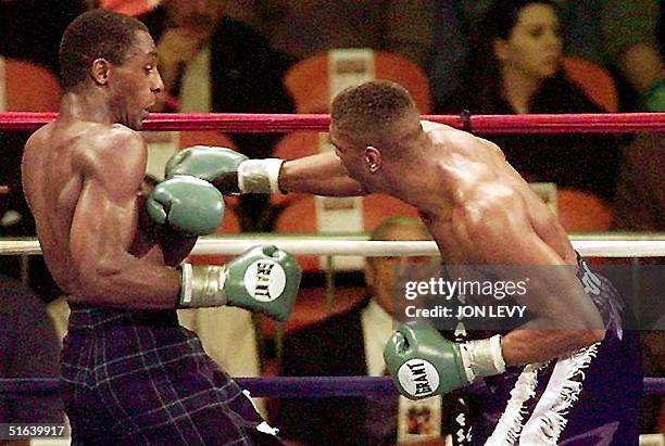 Herol Graham of the United Kingdom avoids a punch from IBF Super Middleweight Champion Charles Brewer of the United States in the third round of...