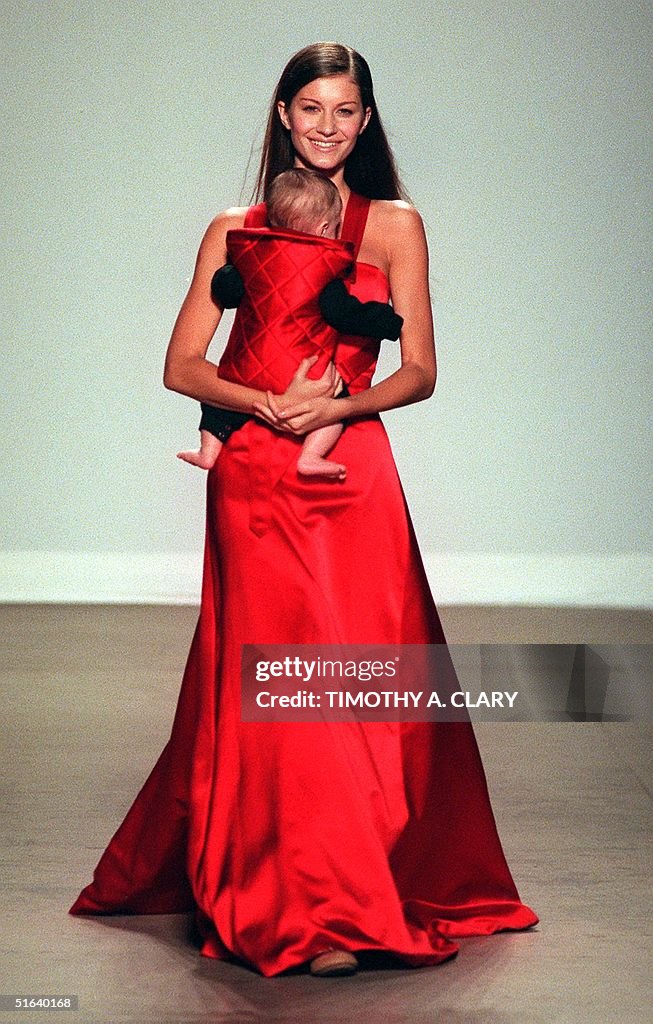 A model wears a red satin gown with a red satin ba