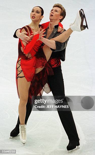 Oleg Ovsyannikov holds the leg of partner Anjelika Krylova of Russia during their performance 03 April in the free dance program at World Figure...