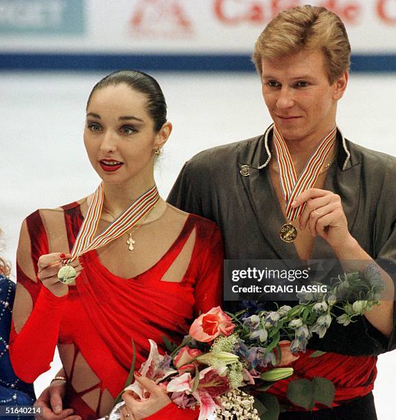 Oleg Ovsyannikov and partner Anjelika Krylova of Russia hold their medals after their performance 03 April in the free dance program at World Figure...