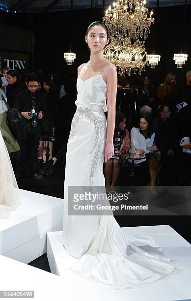 Models pose wearing Di Carlo Couture 2016 collection during Toronto Fashion Week Fall 2016 at David Pecaut Square on March 18, 2016 in Toronto,...