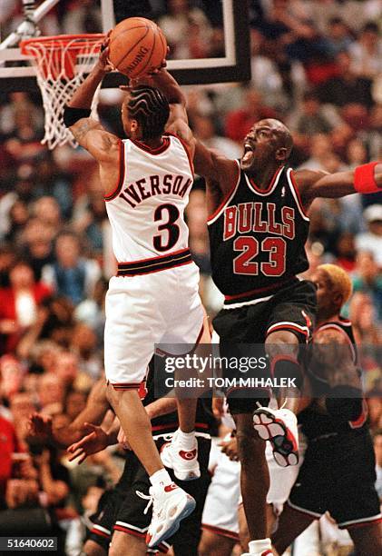 Thiladelphia 76ers Allen Iverson finds the Chicago Bulls Michael Jordan in the path to the basket 17 April in Philadelphia. The Bulls won 87-80,...